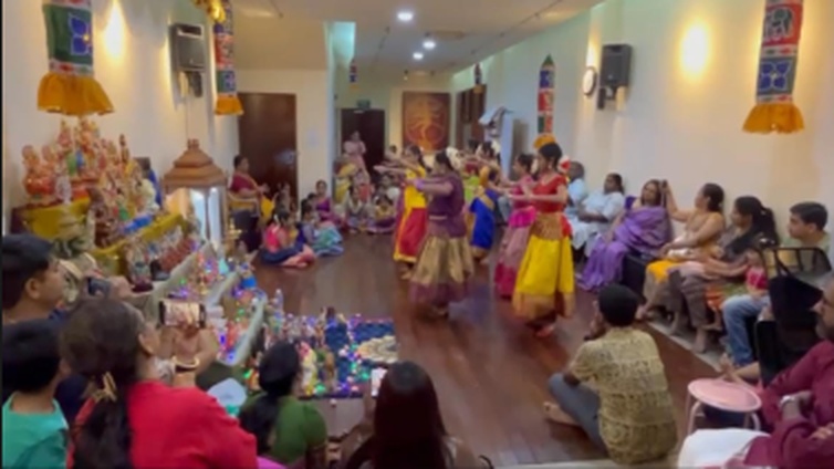 The Taranga cultural team performing a group dance in colourful saris at the Hindu Centre